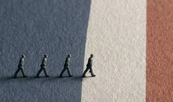 plastic men walking on a French flag