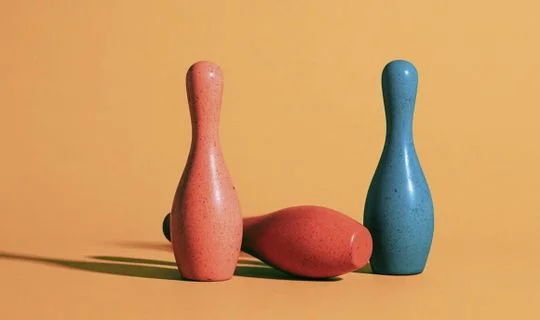 bowling pins, one has fallen over 