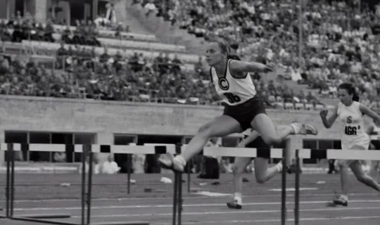 woman jumping a hurdle 