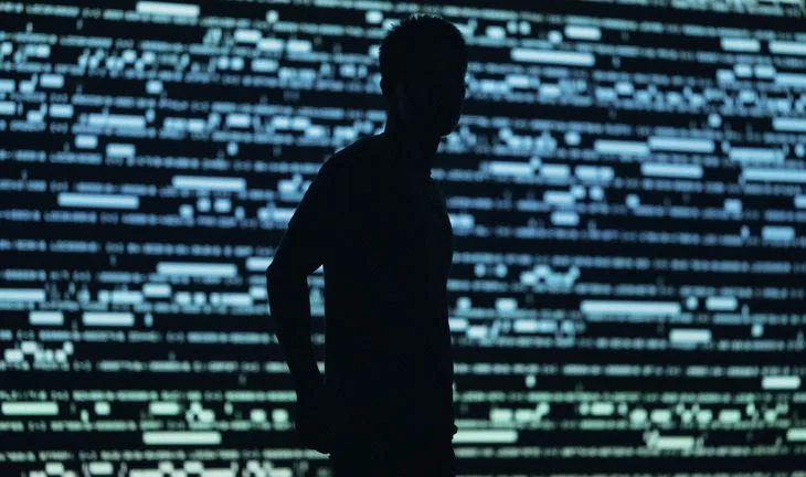 A man standing in front of a screen 