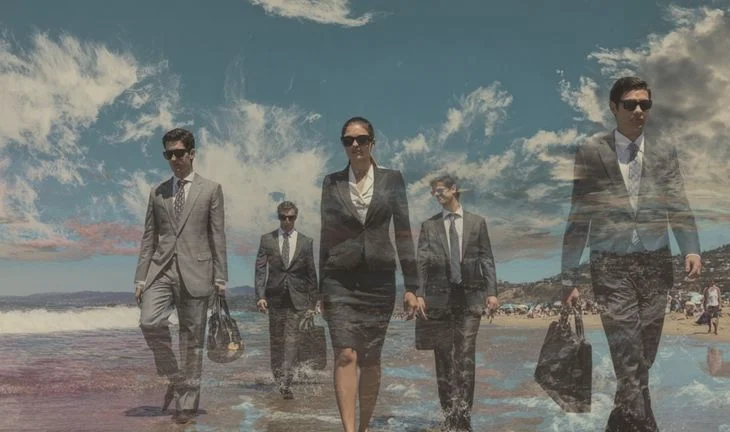 bankers walking along a beach 