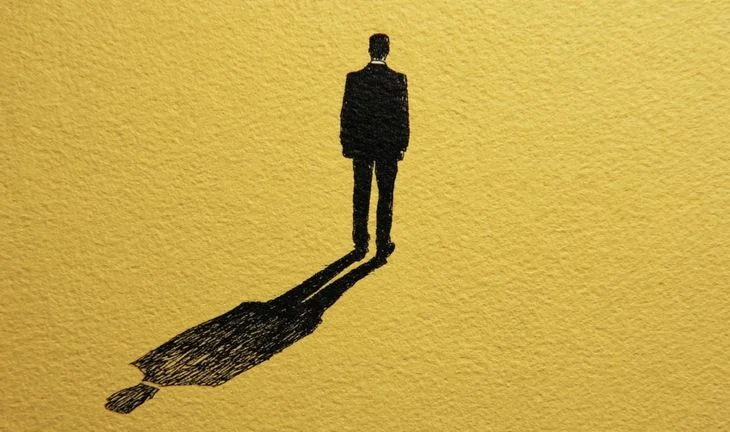 a man and his shadow against a yellow background 