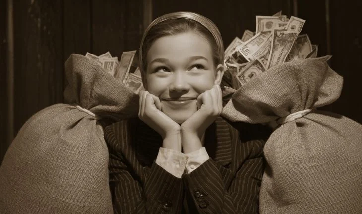 a young woman next to bags of money in the 1950s