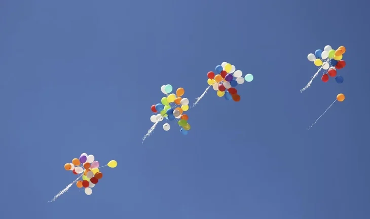 balloons flying away